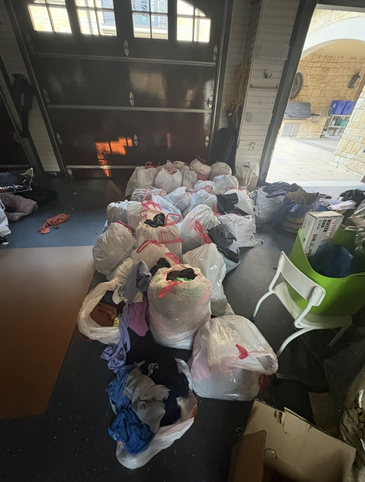 Bags of donated clothing collected before the thrift sale