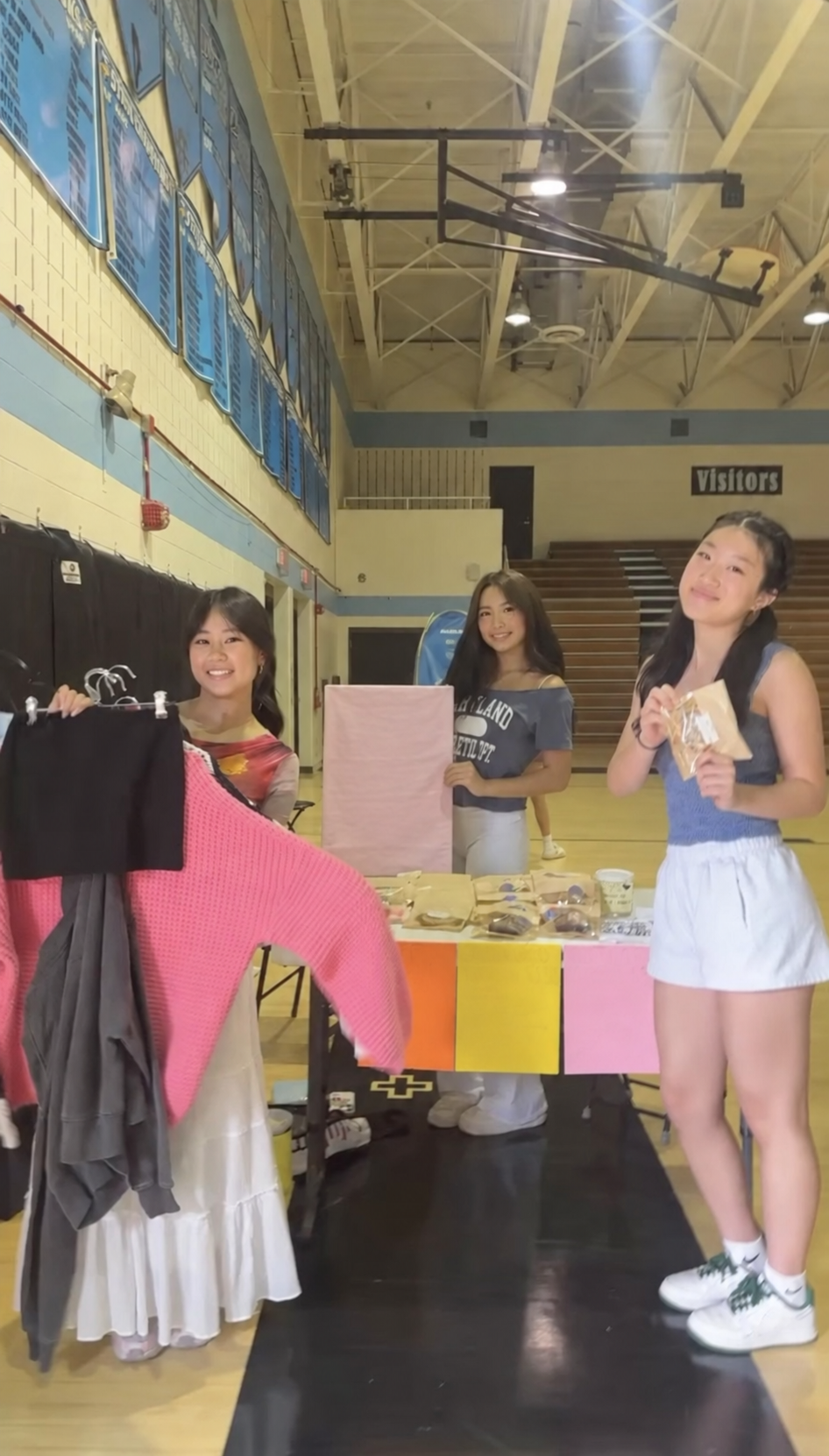 Friends and volunteers standing behind a table during the Project Sewing Hope thrift sale